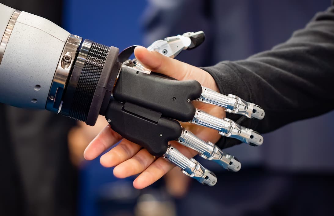 Meet Your New AI Team Section - image of robot and human shaking hands