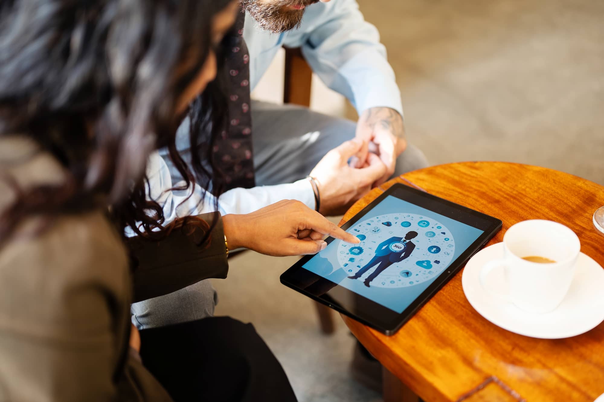 Section image - image of colleagues viewing a tablet with at 360 view of a customer