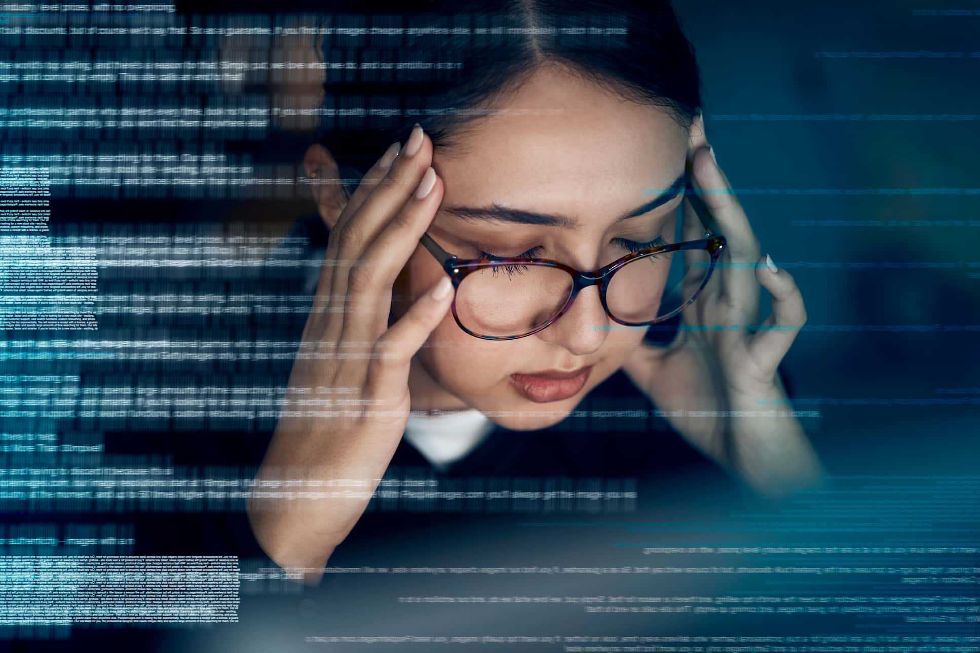 Section image - image of woman looking stressed with her hands on her head and streams of data to the left