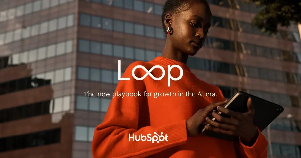 INTRODUCING Loop Marketing - HubSpot graphic of woman holding a tablet in front of an office building